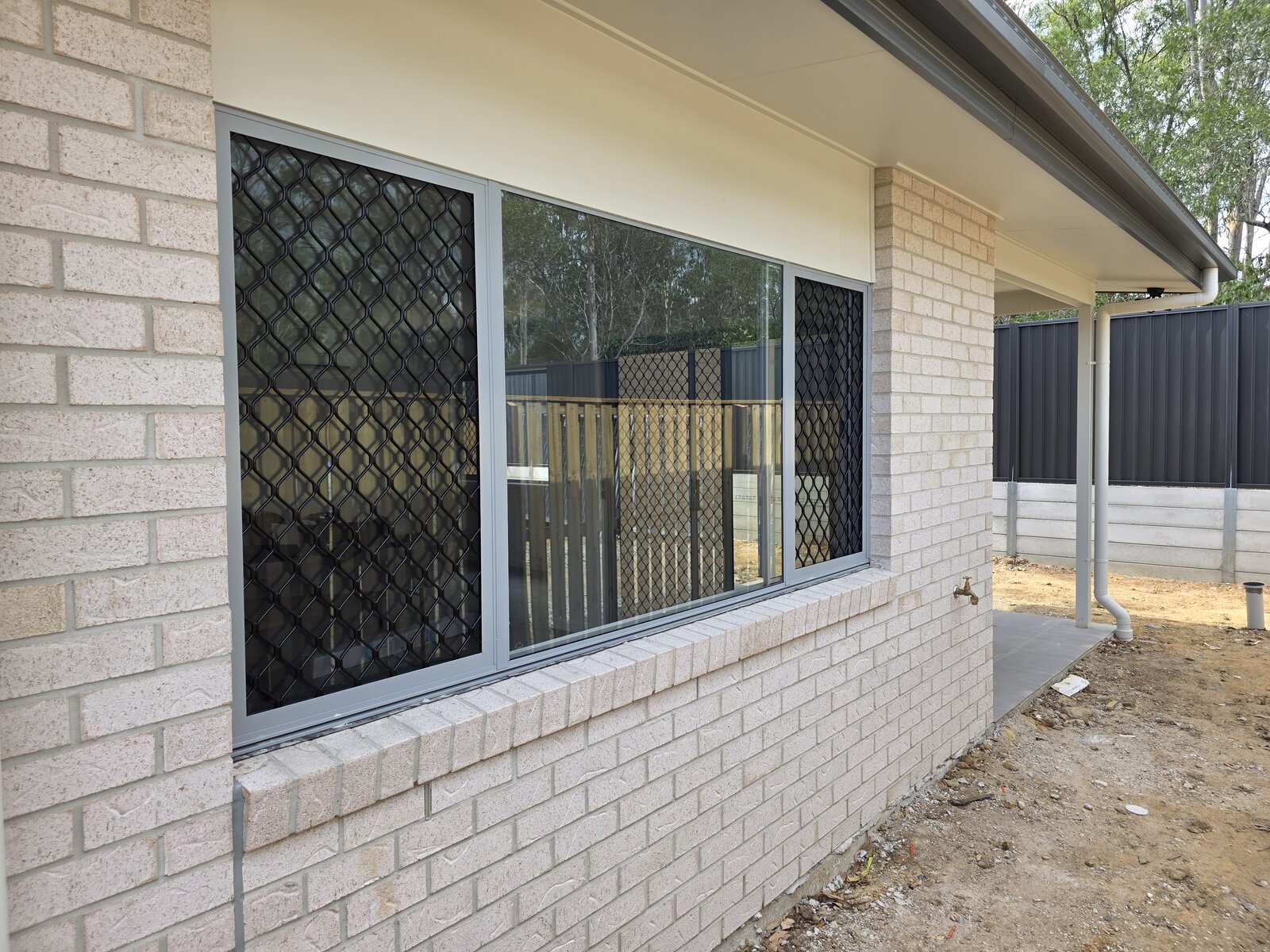 Barrier window screen installation on Gold Coast home